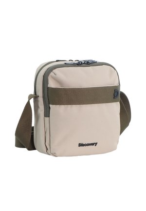 Kompakte beige Umhängetasche mit dunkelgrünem Gurt, vorderer Reißverschlusstasche und "Discovery"-Logo auf der unteren Vorderseite.