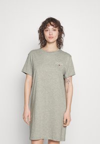 Grå bomulls t-shirtklänning med avslappnad passform, korta ärmar och rund halsringning. Har en liten logotryck framtill.