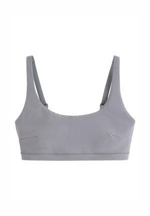 Bralette grigia con un design semplice, spalline sottili regolabili e texture liscia. Presenta una cucitura discreta e nessun imbottitura.