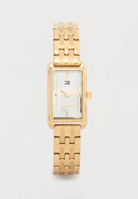 Gold-tone rectangular watch with a metal link bracelet, white face, gold hour markers, and a small logo. Simple design with a classic look.