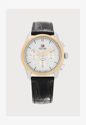 Montre ronde bicolore argent et or Tommy Hilfiger à double affichage, avec cadran blanc, trois sous-cadrans, aiguilles dorées et bracelet en cuir noir.