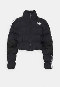 Black cropped puffer jacket with high collar, front zipper, white logo on chest, and white stripes down the sleeves.