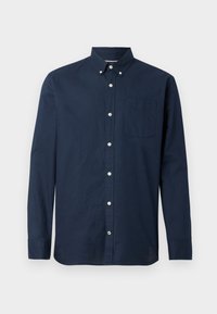 Camicia blu navy con bottoni, maniche lunghe, tasca applicata e bottoni bianchi. Realizzata in cotone dalla trama lavorata. Nessun motivo o dettaglio visibile.