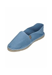 Blue canvas espadrille with a slip-on design, jute sole, and stitched detailing around the edge. Smooth texture and minimalistic style.