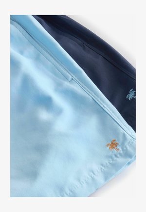 Plavalne hlače v svetlo modri in mornarsko modri tkanini, z kontrastnim šivanjem. Svetlo modra stran ima majhen vezen zlati palmov drevesček.