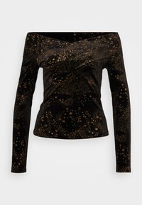 Top lungo in velluto nero con scollatura off-the-shoulder, decorato con stelle dorate e motivi a pois. Texture liscia, forma aderente.