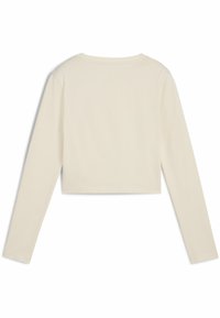 Pitkähihainen, cropped-top kevytbežissä. Ominaisuuksiin kuuluu pyöreä pääntie ja sileä pinta, jossa on minimimäärä saumoja, suunniteltu istumaan tiiviisti.
