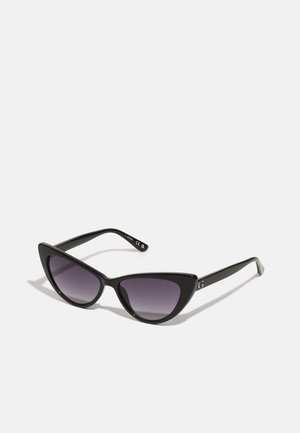 Black cat-eye sunglasses with gradient dark lenses, glossy plastic frame, pointed outer edges, and subtle logo detail on the arm.