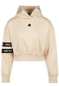 Hoodie beige accorciato realizzato in tessuto morbido. Presenta un logo di gorilla nero sul petto e strisce nere a contrasto con testo sulle maniche.