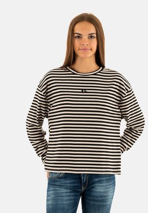 Camisa de manga larga a rayas negra y crema con cuello redondo y corte relajado, hecha de una tela suave y texturizada. Detalle del logo pequeño en la parte frontal.
