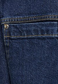 Džínsy z denimu v tmavomodrej farbe s jemnou textúrou, vybavené malým strieborným nitom v tvare srdca pri zadnej vrecku a kontrastným žltým prešívaním.