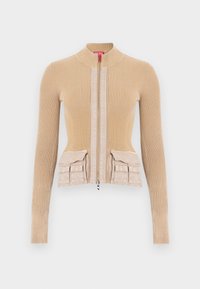 Μπεζ πλεκτό μπουφάν με ραβδώσεις, ψηλό γιακά, εμπρόσθιο φερμουάρ και δύο πλαϊνές τσέπες στη μέση, με λεπτομέρειες από λείο ύφασμα στο εμπρός μέρος.