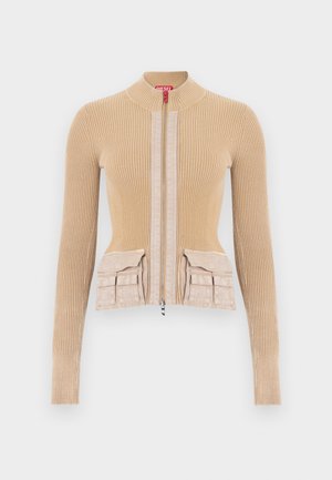 Μπεζ πλεκτό μπουφάν με ραβδώσεις, ψηλό γιακά, εμπρόσθιο φερμουάρ και δύο πλαϊνές τσέπες στη μέση, με λεπτομέρειες από λείο ύφασμα στο εμπρός μέρος.