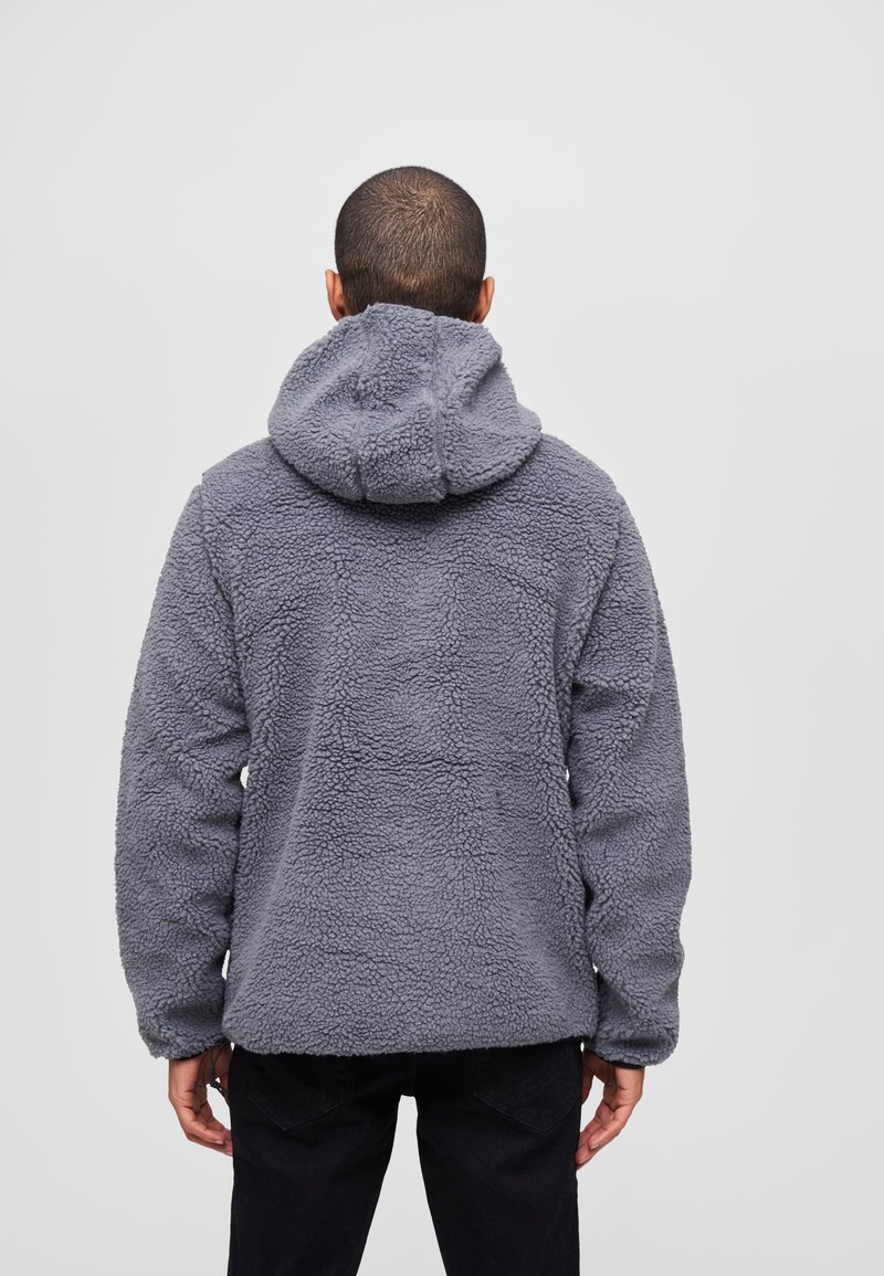 Gray fleece jacket with a textured, fluffy surface, featuring a hood and long sleeves, viewed from the back against a plain backdrop.