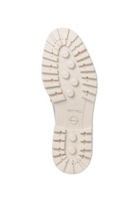 Podeszwa buta z teksturowanej, jasnobeżowej gumy, z głębokimi rowkami i okrągłymi akcentami dla lepszej trakcji i stabilności.