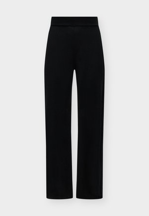 Pantalon noir à jambes droites avec une large taille élastique, sur un fond uni clair.