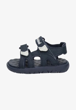Dark blue sandal with open toe design, featuring adjustable straps, breathable upper material, and textured sole for grip.