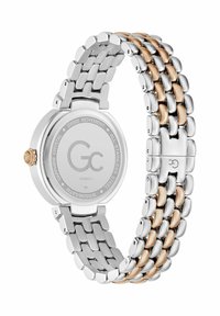 Ceas din oțel inoxidabil cu tonuri de argint și aur, cu carcasă rotundă, brățară legată și cristal de safir. Prezintă o finisare lustruită și un capac gravat.