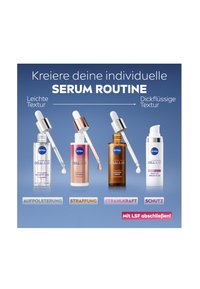 Four serum bottles with droppers: clear, frosted, amber, and white. Each has distinct labels and different textures. Blue background.