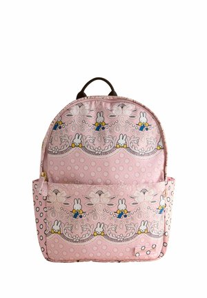 Pink fabric backpack with rounded shape, featuring a pattern of bunny illustrations, flowers, and polka dots. Includes a front zip pocket.