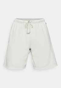 Pantalones cortos de mezcla de algodón verde claro con cintura elástica y cordón. Con bolsillos laterales y un pequeño logotipo en la parte delantera de la pierna izquierda.