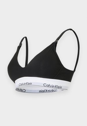 Schwarzer Bralette aus weichem Stoff, mit dreieckigen Cups und verstellbaren Trägern. Weißes Band mit "Calvin Klein"-Logo am unteren Rand.