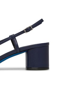 Sandal in pelle blu navy con tacco largo, sottile cinturino regolabile e soletta blu a contrasto. Texture liscia e design minimalista.