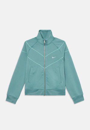 Mintgrünes Zip-Jackett aus glattem Material, mit hohem Kragen, schrägen Nähten und kontrastierendem weißen Nähen entlang des Designs.