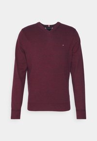 Burgundowy sweter z dekoltem w kształcie litery V, z długim rękawem, z małym haftowanym logo na lewym piersi oraz ściągaczami przy mankietach i hemie.