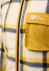 Giacca in pile con motivo a quadri giallo e blu navy, dotata di zip frontale e taschino sul petto in giallo uniforme con dettaglio del marchio.