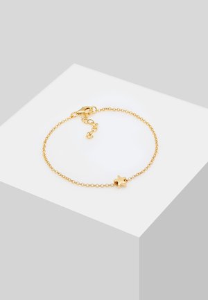 Bracelet en chaîne dorée avec un charme en étoile, maillons délicats, fermeture à ressort, et longueur ajustable. Fini brillant, design minimal.