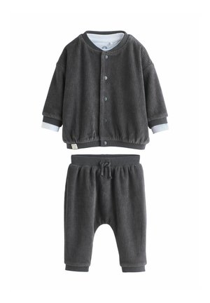 Gray ribbed corduroy unisex outfit featuring a button-up jacket with elastic cuffs and matching elastic waist pants with a drawstring.