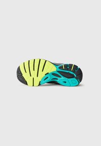 Running shoe sole with black, neon yellow, and turquoise tread patterns on a white background.