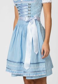 Light blue dirndl dress featuring a textured fabric with polka dots, lace trim, a satin ribbon tie at the waist, and floral accents.