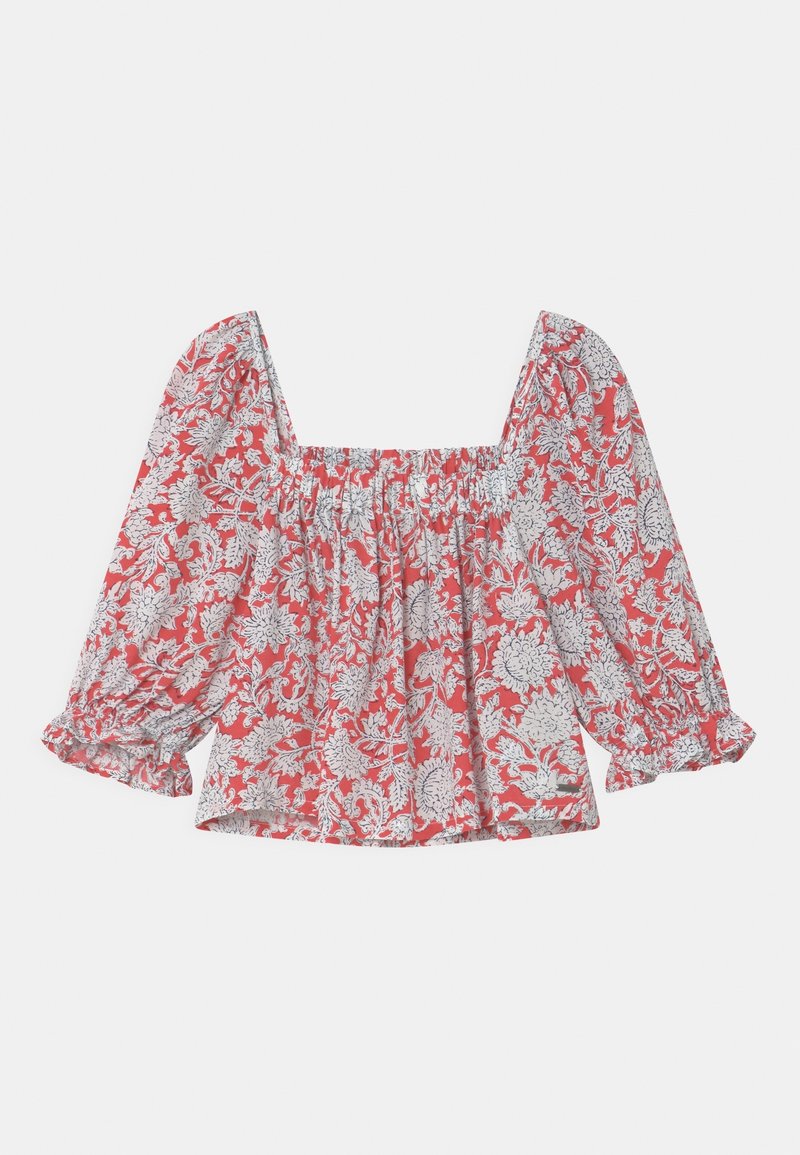 Blusa rossa con motivo floreale bianco, scollatura quadrata e maniche lunghe a sbuffo con polsini elastici.