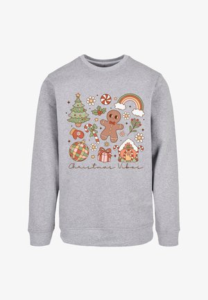 Grauer Pullover mit festlichem Design und weihnachtlichen Illustrationen: Lebkuchenmann, Baum, Geschenke, Zuckerstangen und ein Regenbogen.