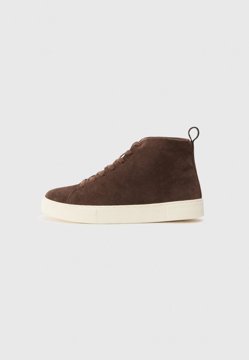 Brown suede ankle sneakers with a white rubber sole, featuring a rounded toe, lace-up design, and a pull tab at the back.
