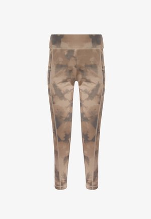 Leggings taille haute tie-dye en beige et marron avec poches latérales et coutures visibles le long des jambes.