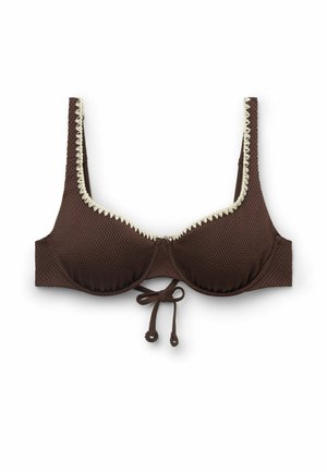Brauner, strukturierter Bügel-BH mit weißem, gezacktem Besatz entlang der oberen Kanten und einer gebundenen Schleife in der Mitte vorne.
