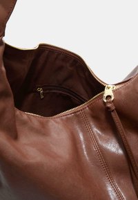 Brown leather bag with a glossy finish, featuring a gold zipper and an interior zip pocket, giving it a sleek and functional design.