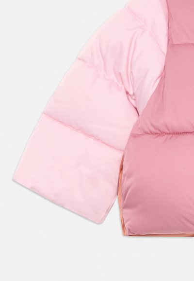 Padded jacket sleeve with a color gradient from light pink to darker pink. Smooth texture, quilted design, and contrasting inner lining.