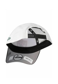 White cap with a black visor, adjustable strap, and mesh lining. Features a green logo on the front and a labeled inner tag.