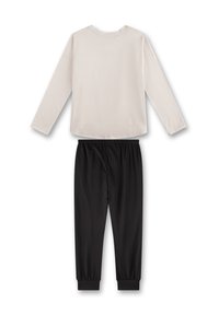 Long-sleeve light beige top with a round neckline paired with black elastic waist joggers featuring tapered cuffs. Cotton blend material.