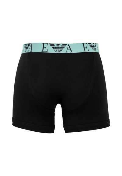 Schwarze Boxershorts mit einem mintgrünen elastischen Bund, der ein stilisiertes Logomuster aufweist, gefertigt aus weichem, dehnbarem Material.