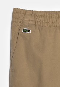 Lacoste Donji dijelovi trenirke - lion