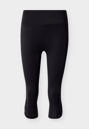 Μαύροι κάπρι κολάν από λεία, ελαστική ύλη. Διαθέτουν ψηλή μέση και ελαφριά ρυτιδωτή λεπτομέρεια στο τελείωμα.