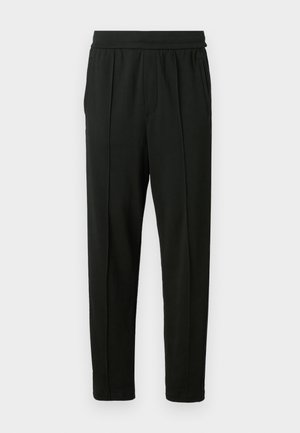 Pantalons noirs en tissu lisse ; dotés d'une taille élastique, de poches latérales et d'un design de jambe fuselée. Minimaliste et de couleur unie.