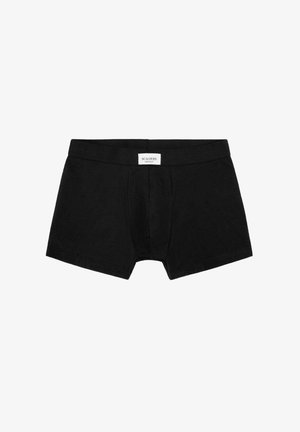 Bóxers para hombres negros con bolsa frontal y una etiqueta blanca en la cintura que dice "Scalpers."