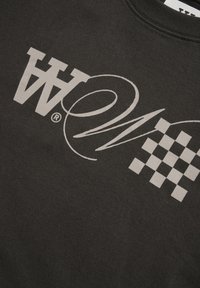 Black sweatshirt featuring large white graphic text and checkered pattern, with a soft texture and crew neckline.
