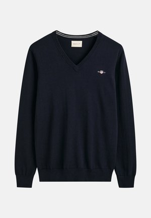 Navyblauwe V-hals sweater van zacht materiaal met lange mouwen en geribbelde manchetten. Voorzien van een klein GANT-logo op de borst.
